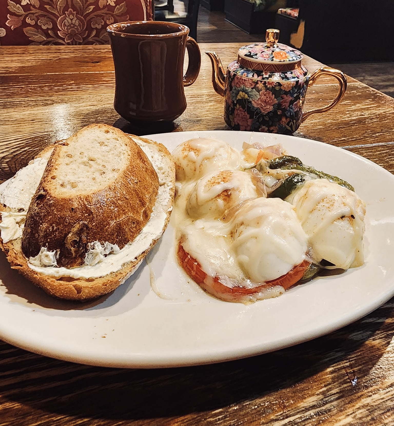 Eggs benedict with fresh teapot on the side