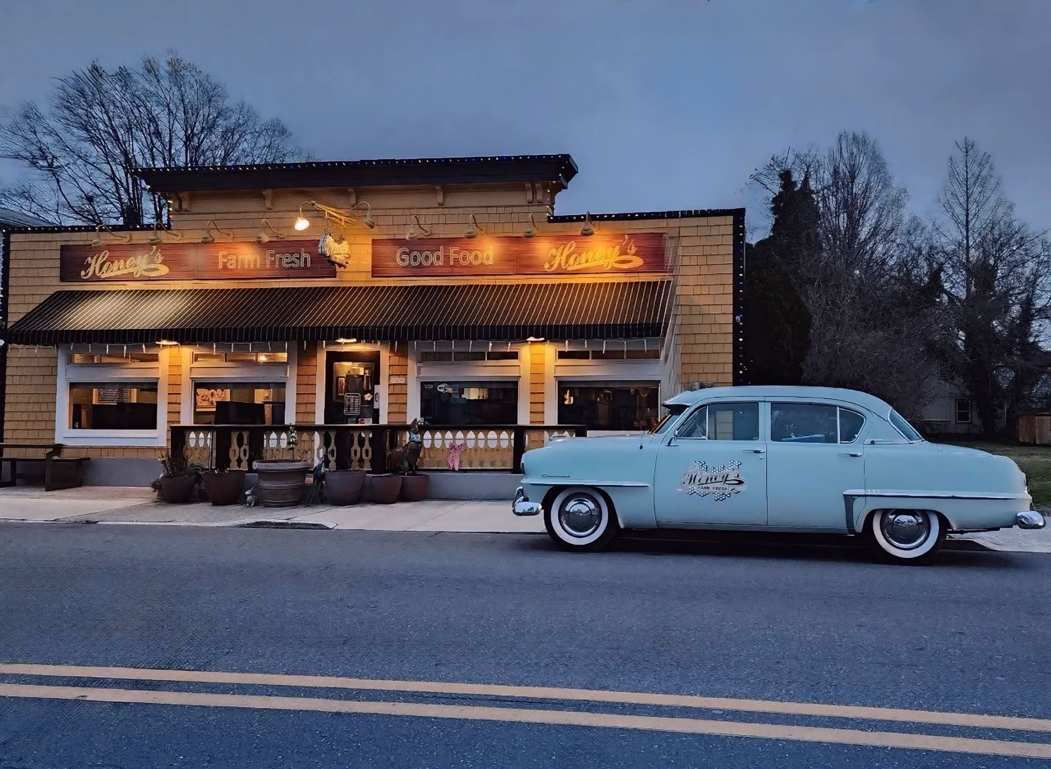 Honey's Farm Fresh restaurant exterior with vintage car at dusk